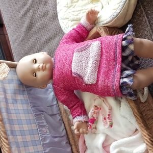 Bitty Baby wicker suitcase, backpack carrier, bitty baby, and clothes.